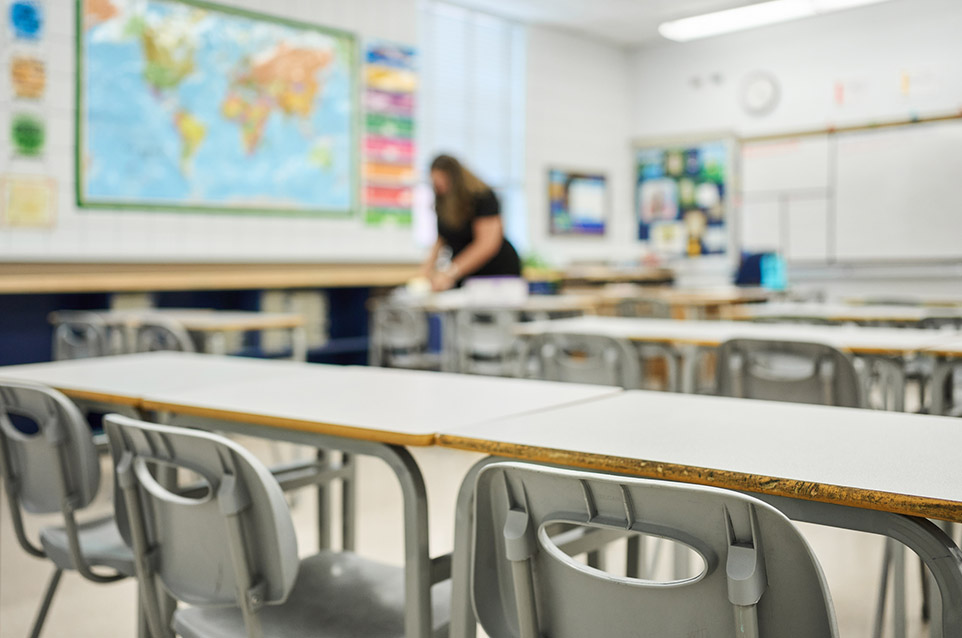 Teacher cleaning the classroom for organization